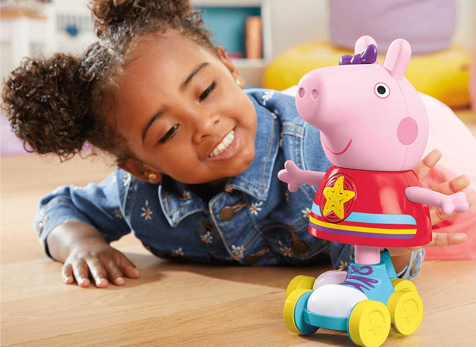 A happy child playing with Cartoon Character Toys from stepsnsmiles Pakistan