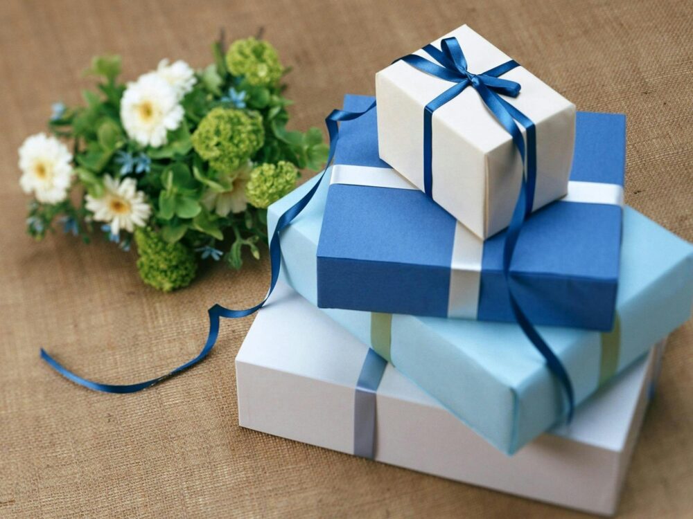 three gift boxes packed in Blue paper with Birthday Gift toys in Pakistan stepsnsmiles Ideas