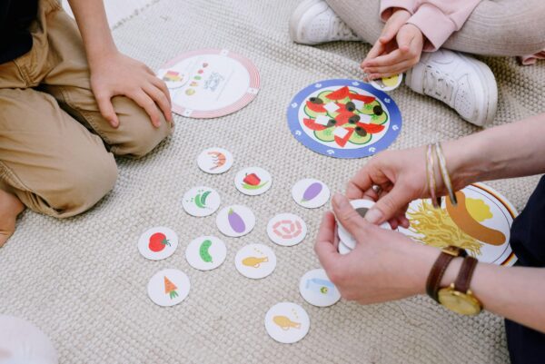 Children in Pakistan playing with interactive toys such as electronic learning boards and augmented reality books.