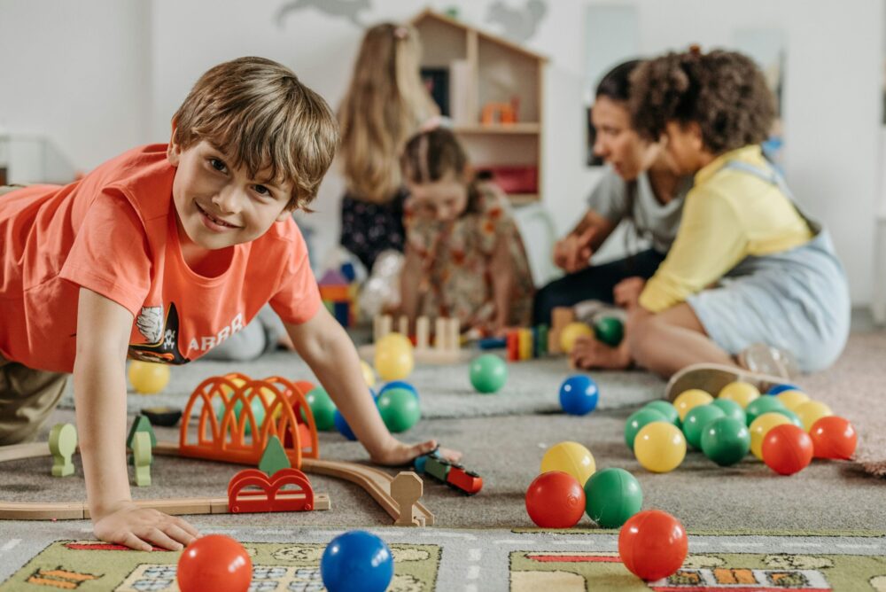 Children playing with colorful educational and sensory toys in a classroom setting, representing inclusive and engaging toys for kids with autism in Pakistan