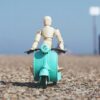 Image showing a character toy riding a scooter toy from stepsnsmiles Pakistan Online